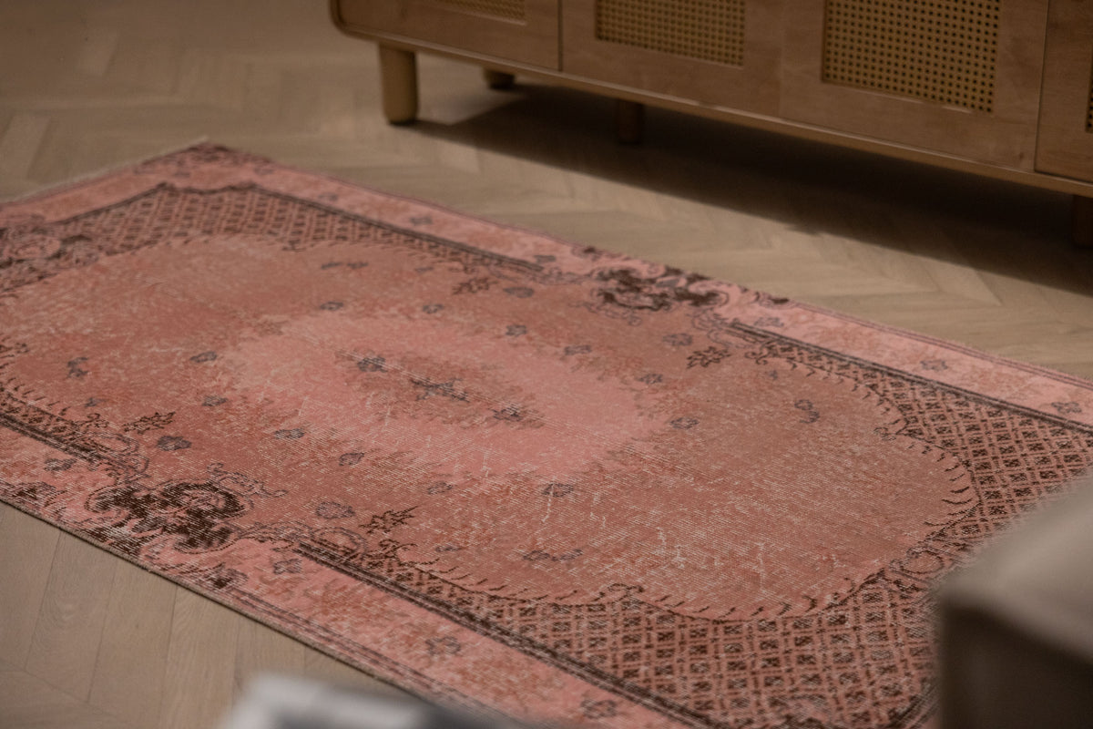 Vintage pink overdyed Turkish Isparta wool rug with floral patterns and a bohemian style, 3x6 ft.