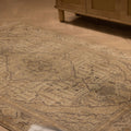 Hand-woven vintage Kayseri rug in gray and brown with intricate floral patterns on a wooden floor.