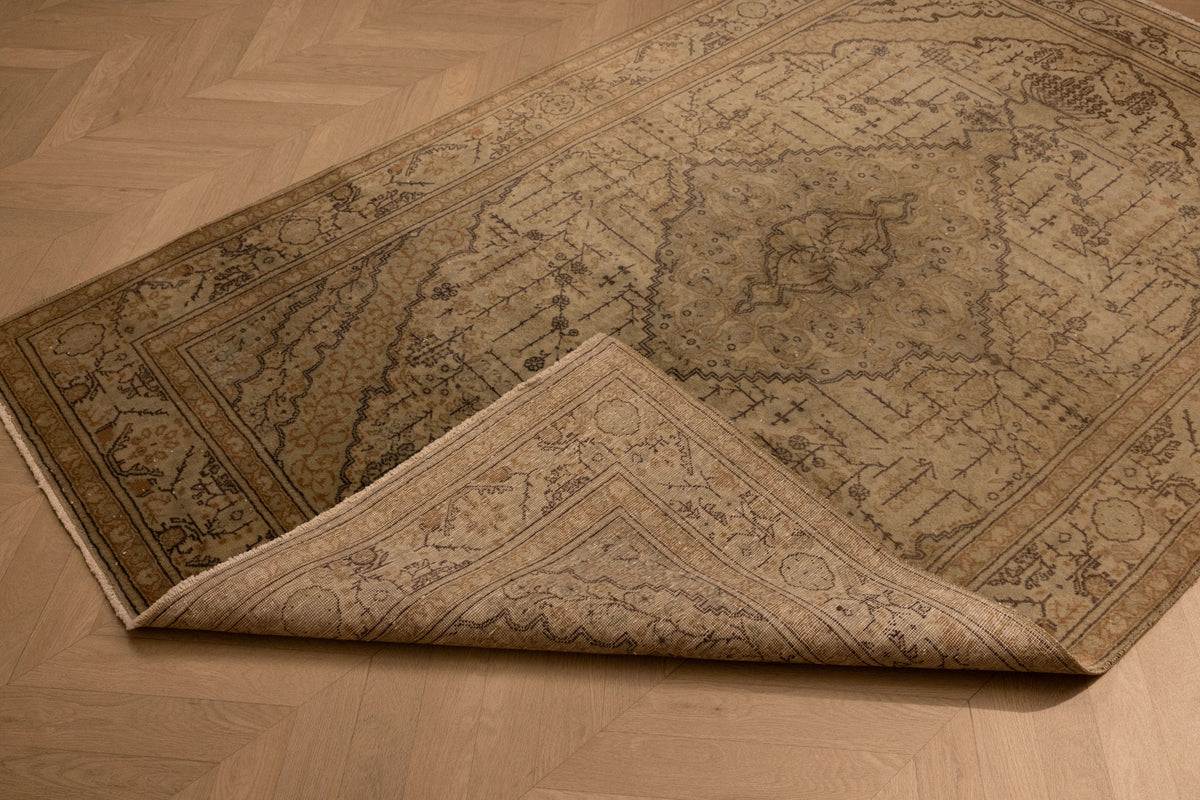 Hand-woven vintage Kayseri rug in gray and brown with floral patterns, 4x7 ft wool and cotton blend on a wooden floor.
