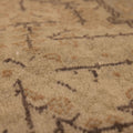 Close-up of a vintage hand-woven Kayseri rug in gray and brown with intricate floral patterns and low-pile wool-cotton texture.