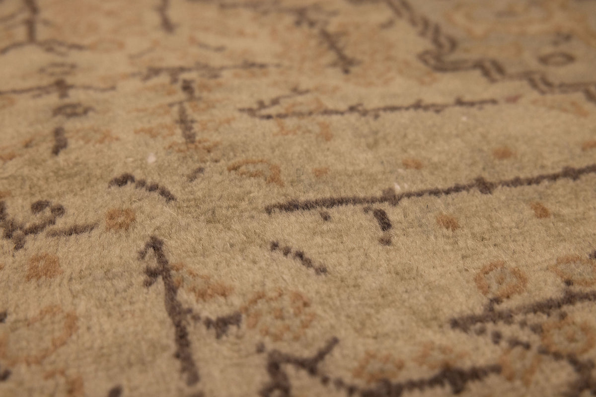 Close-up of a vintage hand-woven Kayseri rug in gray and brown with intricate floral patterns and low-pile wool-cotton texture.