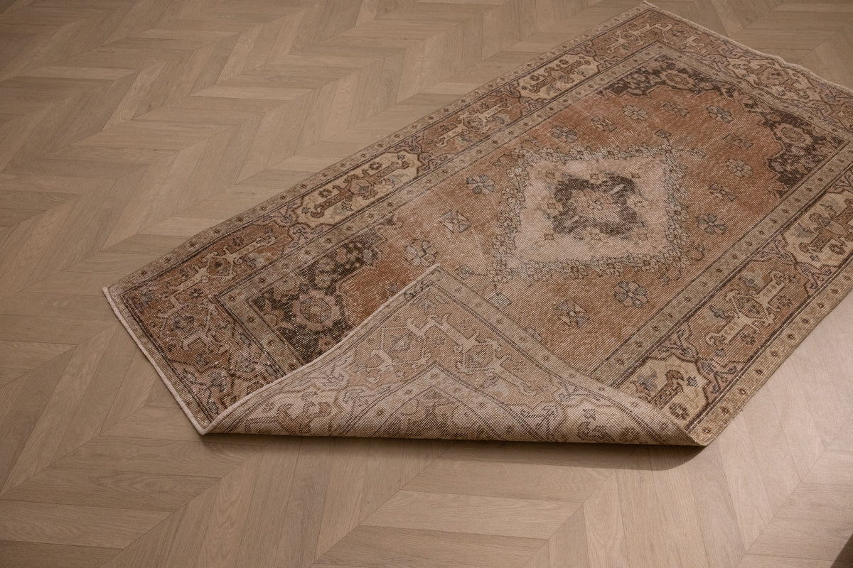 Vintage 4x7 ft hand-woven Isparta wool and cotton rug in earthy brown with maximalist floral patterns.