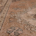 Vintage 4x7 ft brown Turkish Isparta rug with hand-woven floral patterns in wool and cotton.
