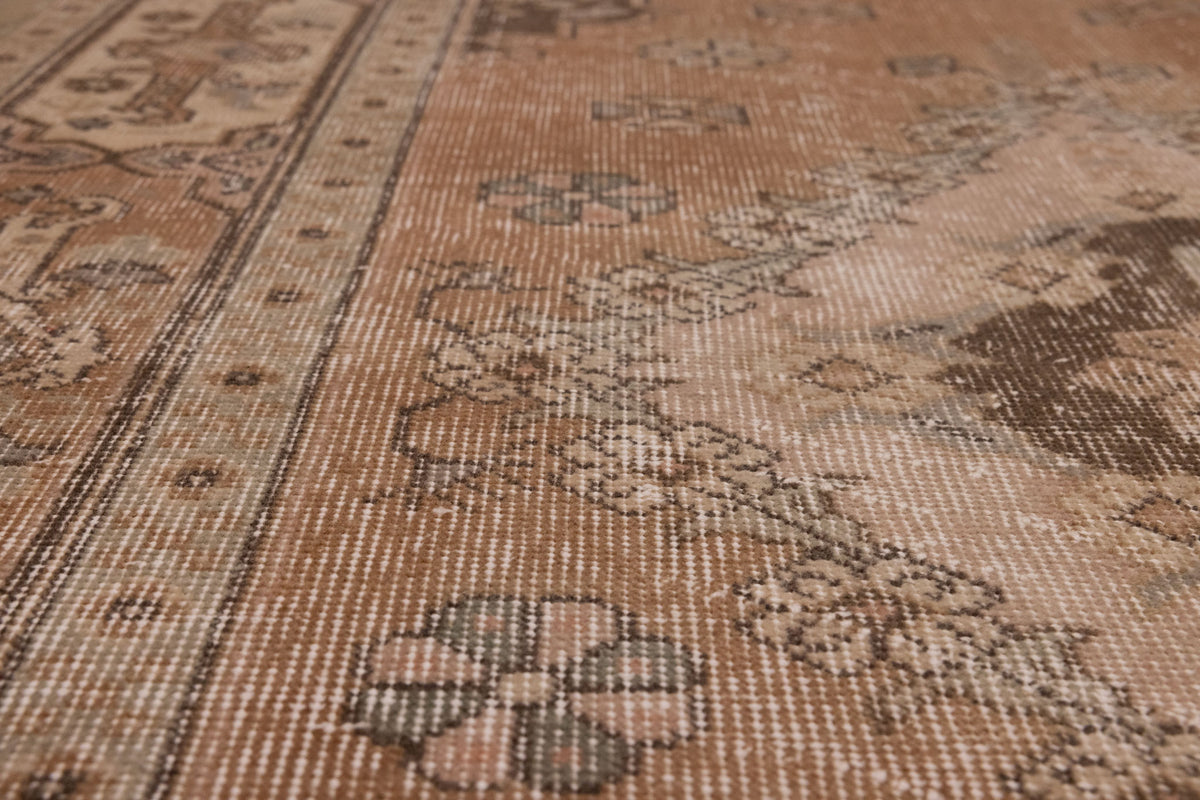 Vintage 4x7 ft brown Turkish Isparta rug with hand-woven floral patterns in wool and cotton.
