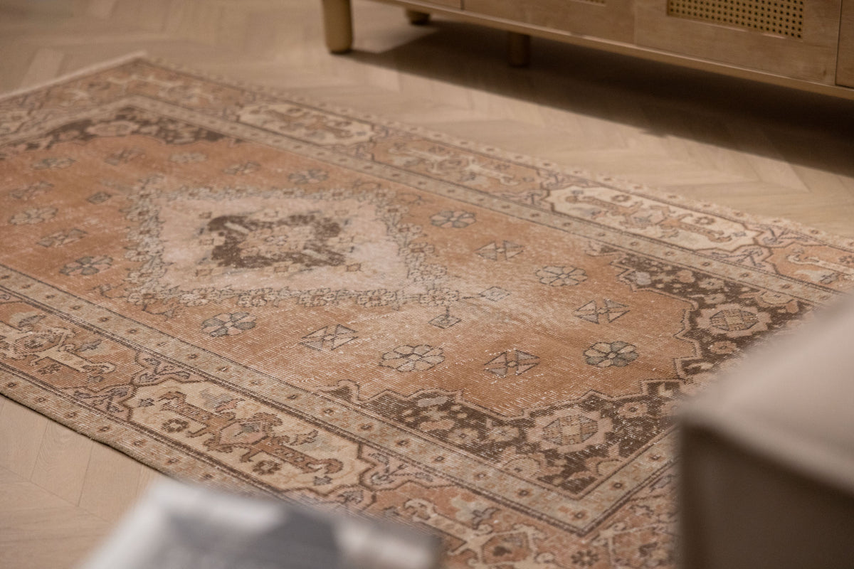 Vintage 4x7 ft brown Turkish Isparta rug with intricate floral motifs and a maximalist wool and cotton weave.