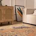 Hand-woven vintage Turkish area rug in orange and beige with a floral medallion design, 4x7 ft wool and cotton blend.
