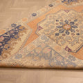 Hand-woven vintage Turkish rug in orange and beige with a floral medallion pattern, 4x7 ft wool and cotton blend.