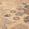 Hand-woven vintage Turkish rug in orange and beige with intricate floral medallion patterns and low-pile wool-cotton texture.