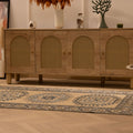 Hand-woven 3x6 ft vintage Oushak wool rug in beige and navy with geometric patterns on a wooden floor.