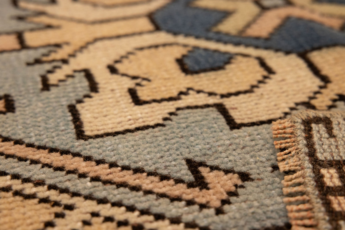 Hand-knotted vintage Oushak wool rug with beige and navy geometric patterns and a textured, low-pile bohemian design.