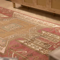 Vintage 4x11 ft Turkish runner rug in red and pink wool with geometric tribal patterns.