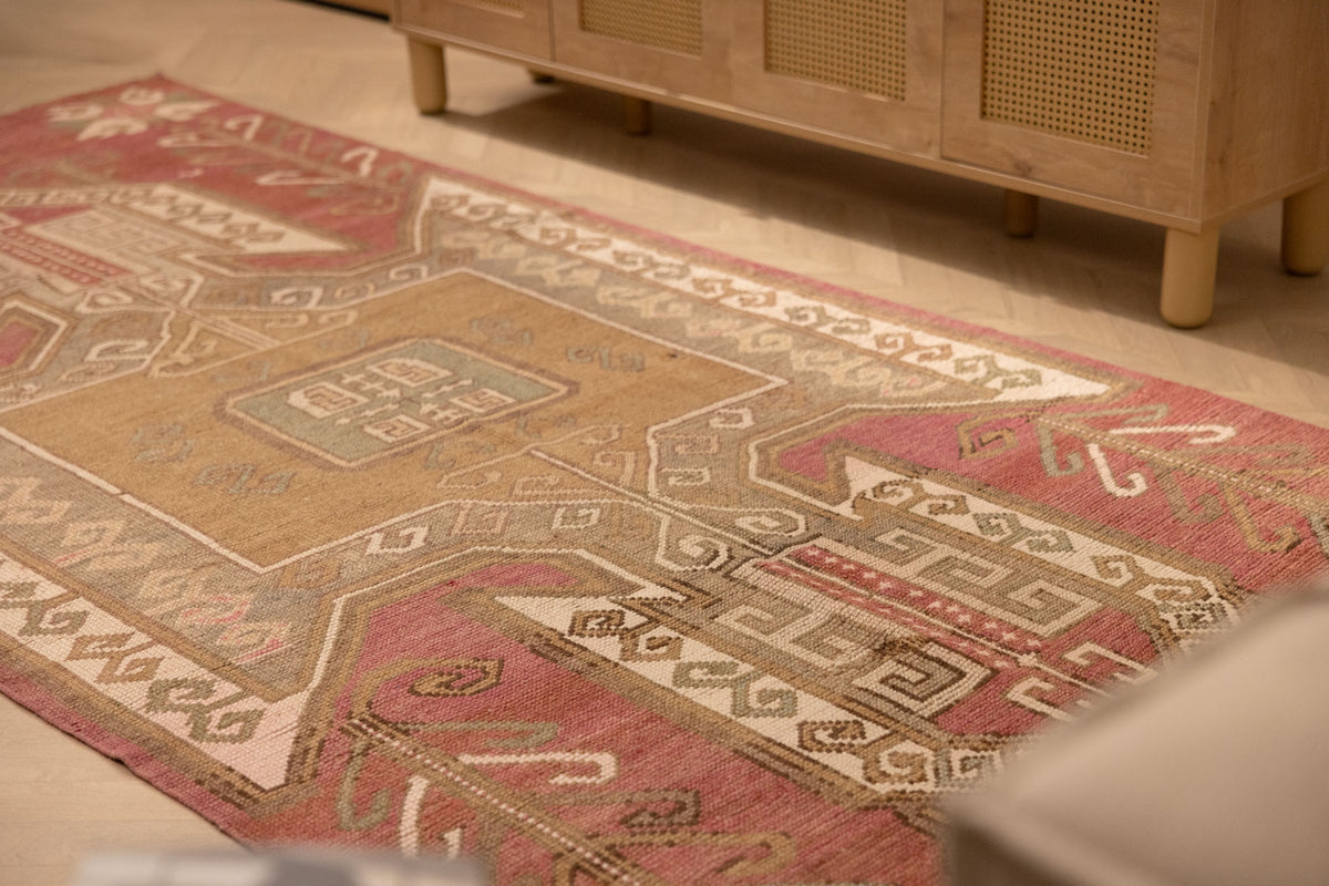 Vintage 4x11 ft Turkish runner rug in red and pink wool with geometric tribal patterns.