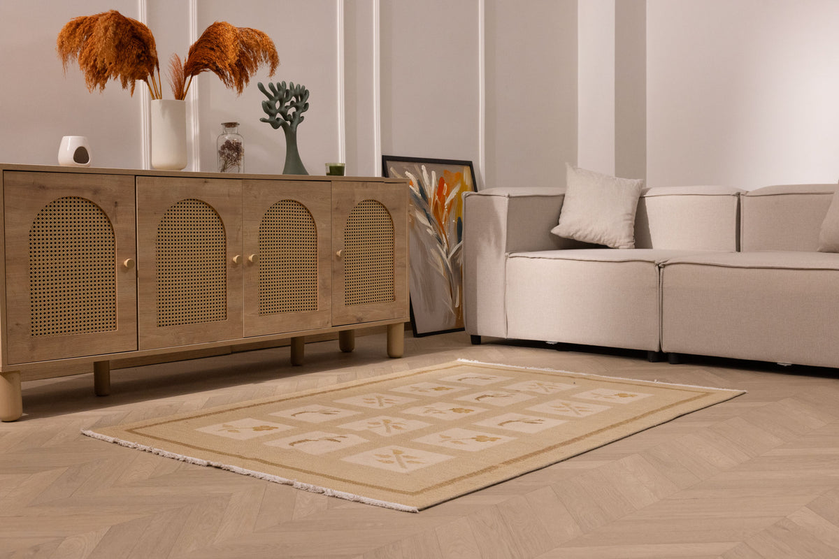 4x5 ft vintage Turkish wool and cotton rug in beige and brown with minimalist floral patterns on a wooden floor.