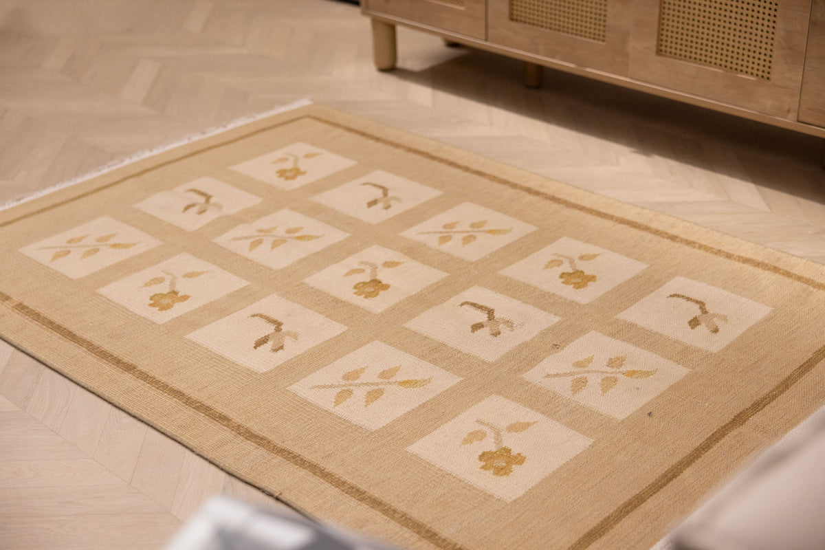 4x5 ft vintage Turkish wool and cotton rug in beige and brown with a minimalist floral grid pattern.