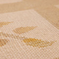 Close-up of a hand-woven beige and brown floral vintage Turkish wool-cotton rug with a flatweave texture.