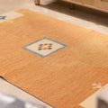 Hand-woven 3x5 ft vintage Turkish rug in orange and beige with minimalist geometric patterns and wool-cotton blend.