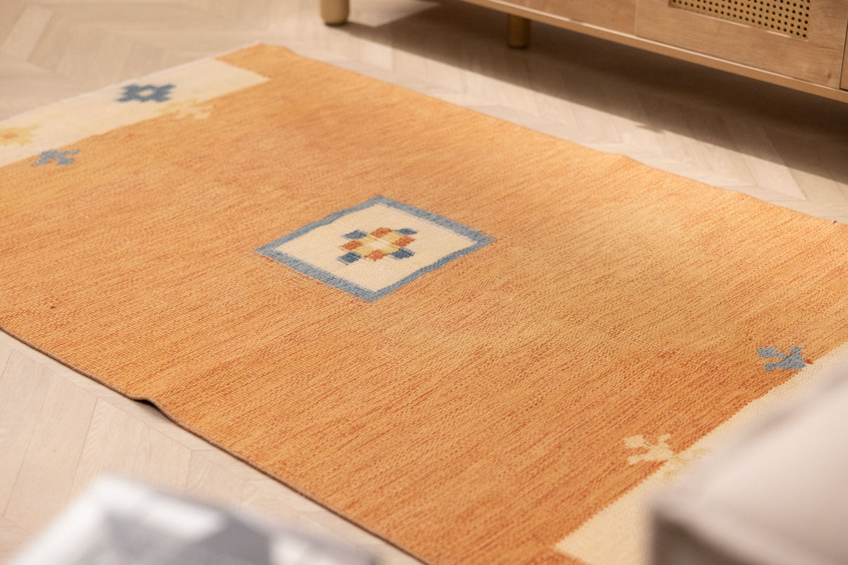 Hand-woven 3x5 ft vintage Turkish rug in orange and beige with minimalist geometric patterns and wool-cotton blend.