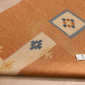 Hand-woven 3x5 ft vintage Turkish rug in orange and beige with minimalist geometric patterns and wool-cotton blend.