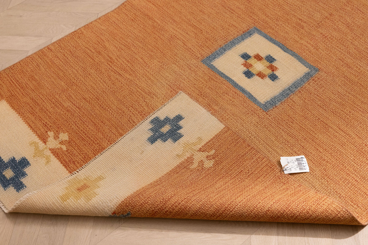 Hand-woven 3x5 ft vintage Turkish rug in orange and beige with minimalist geometric patterns and wool-cotton blend.