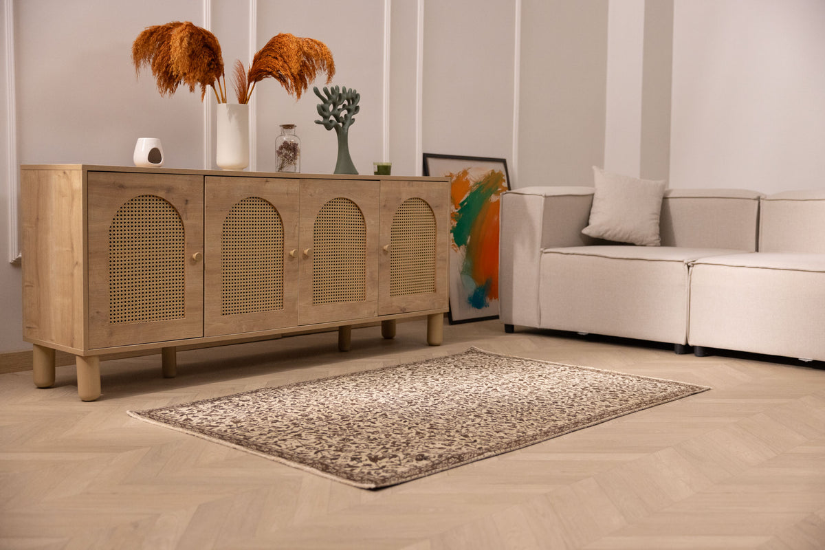 Hand-woven 1x3 ft vintage Isparta rug in beige and brown with intricate floral patterns on a wooden floor.