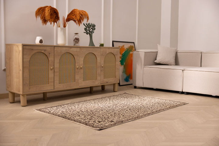 Hand-woven 1x3 ft vintage Isparta rug in beige and brown with intricate floral patterns on a wooden floor.