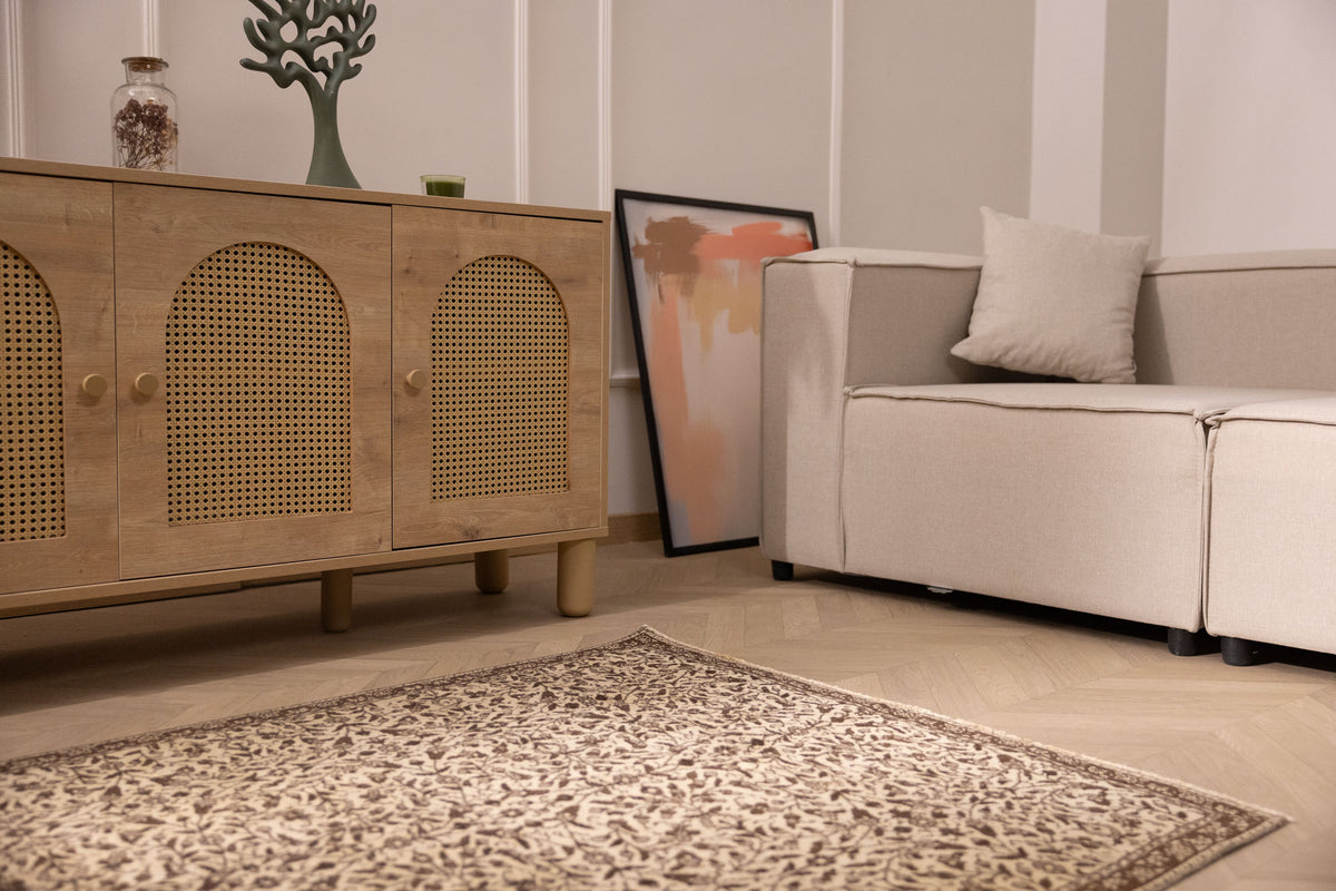 Hand-woven 1x3 ft vintage Isparta rug in beige and brown with intricate floral patterns on a wooden floor.