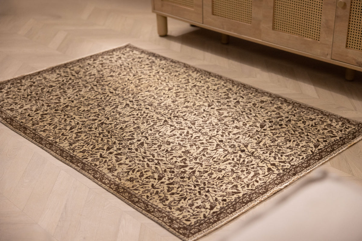 Hand-woven vintage Isparta wool and cotton rug in beige and brown with an intricate floral maximalist pattern.