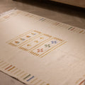 Hand-woven 3x5 ft beige and brown Turkish wool-cotton flatweave rug with minimalist striped borders and floral motifs.
