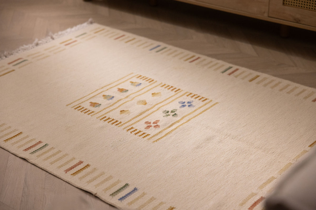 Hand-woven 3x5 ft beige and brown Turkish wool-cotton flatweave rug with minimalist striped borders and floral motifs.