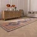 Vintage 4x12 ft Turkish runner rug in orange and navy with geometric patterns, handwoven from wool and cotton.
