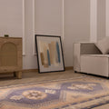 Hand-knotted 4x12 ft vintage Turkish runner rug in orange and navy with geometric patterns in a modern living room.