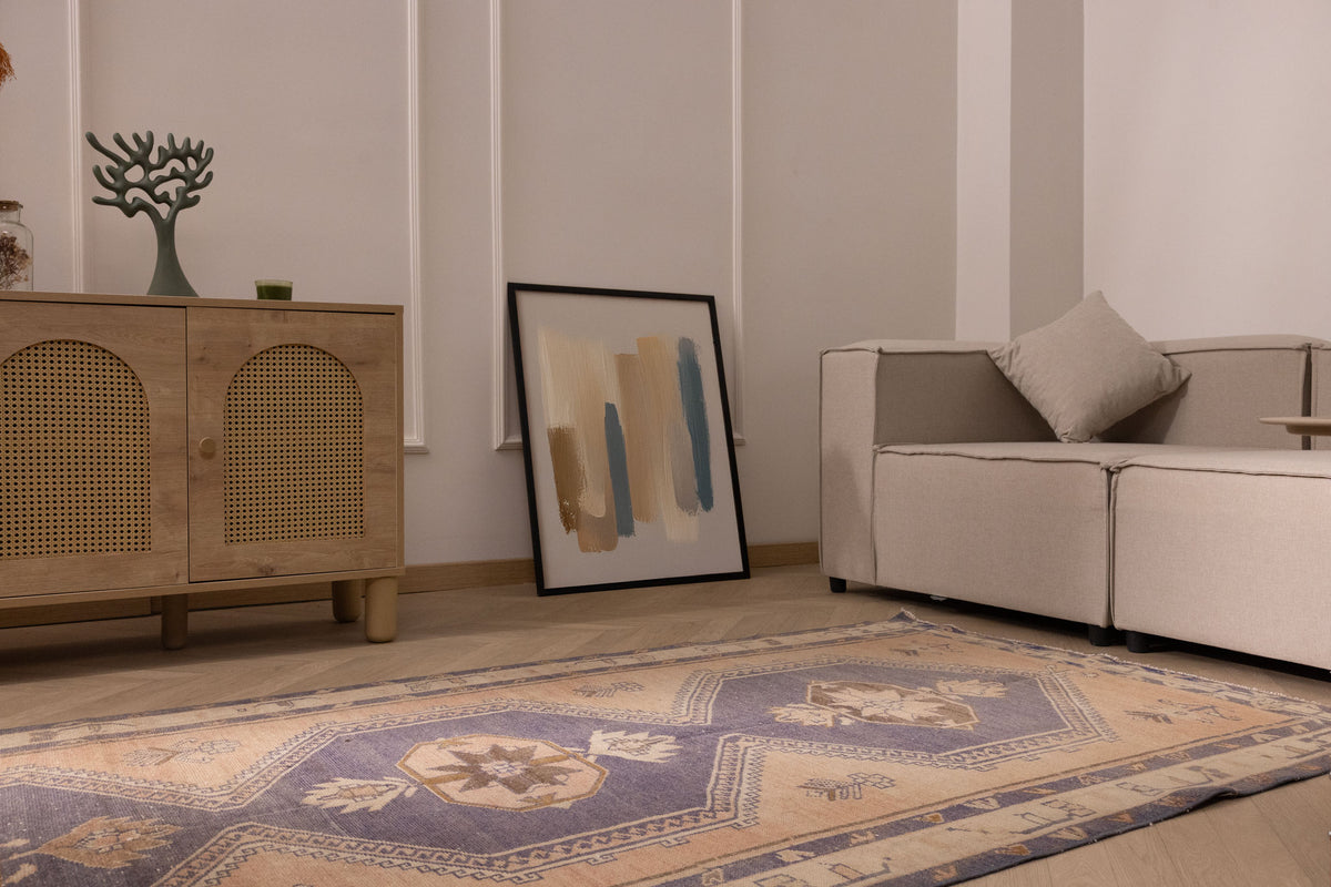 Hand-knotted 4x12 ft vintage Turkish runner rug in orange and navy with geometric patterns in a modern living room.
