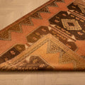 Vintage 4x11 ft Turkish runner rug in orange and brown with geometric patterns, handwoven from wool and cotton.