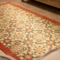 Hand-woven vintage Isparta Turkish runner rug with red and white floral patterns in wool and cotton.