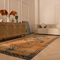 Vintage 4x11 ft Turkish runner rug in orange and brown wool with geometric patterns in a modern living room.