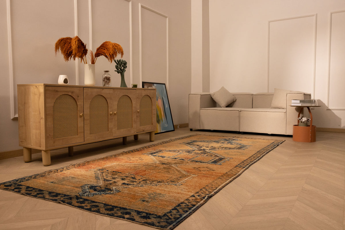 Vintage 4x11 ft Turkish runner rug in orange and brown wool with geometric patterns in a modern living room.