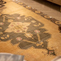 Handwoven vintage Turkish runner rug in beige and gray with geometric patterns, crafted from wool and cotton.