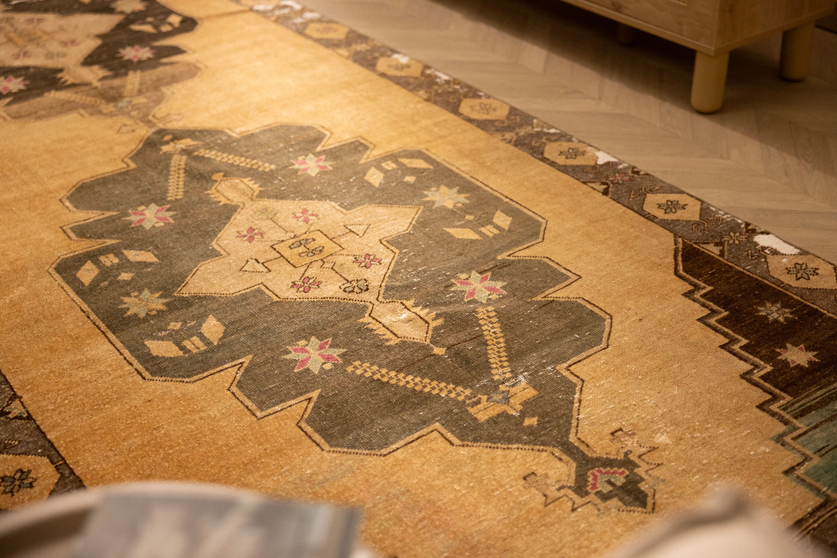 Handwoven vintage Turkish runner rug in beige and gray with geometric patterns, crafted from wool and cotton.