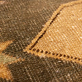 Close-up of a hand-woven vintage Turkish wool and cotton runner rug with beige and gray geometric tribal patterns.