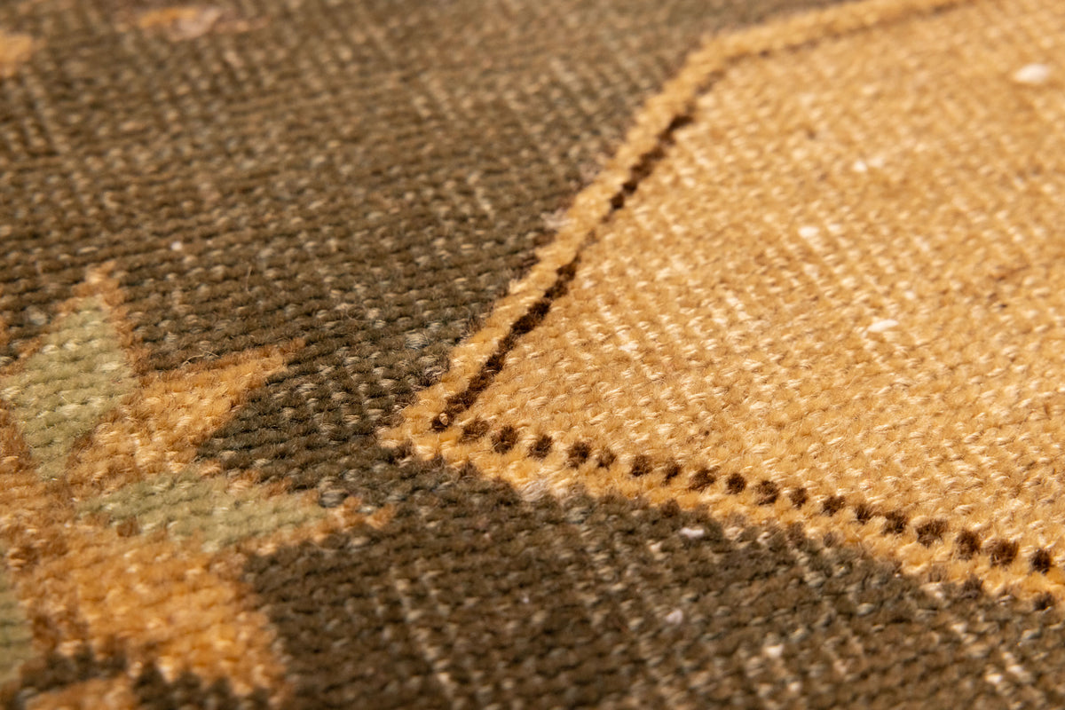 Close-up of a hand-woven vintage Turkish wool and cotton runner rug with beige and gray geometric tribal patterns.