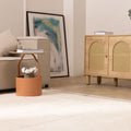Handwoven brown shaggy wool rug with a thick, soft pile texture in a cozy, modern living room setting.