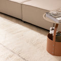 Luxurious brown shaggy wool rug with a thick, handwoven high-pile texture in a cozy, modern living room setting.