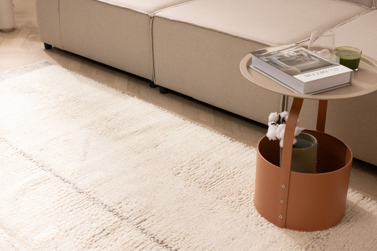 Luxurious brown shaggy wool rug with a thick, handwoven high-pile texture in a cozy, modern living room setting.