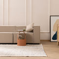 Handwoven white and blue striped wool-blend flatweave rug in a modern living room setting.