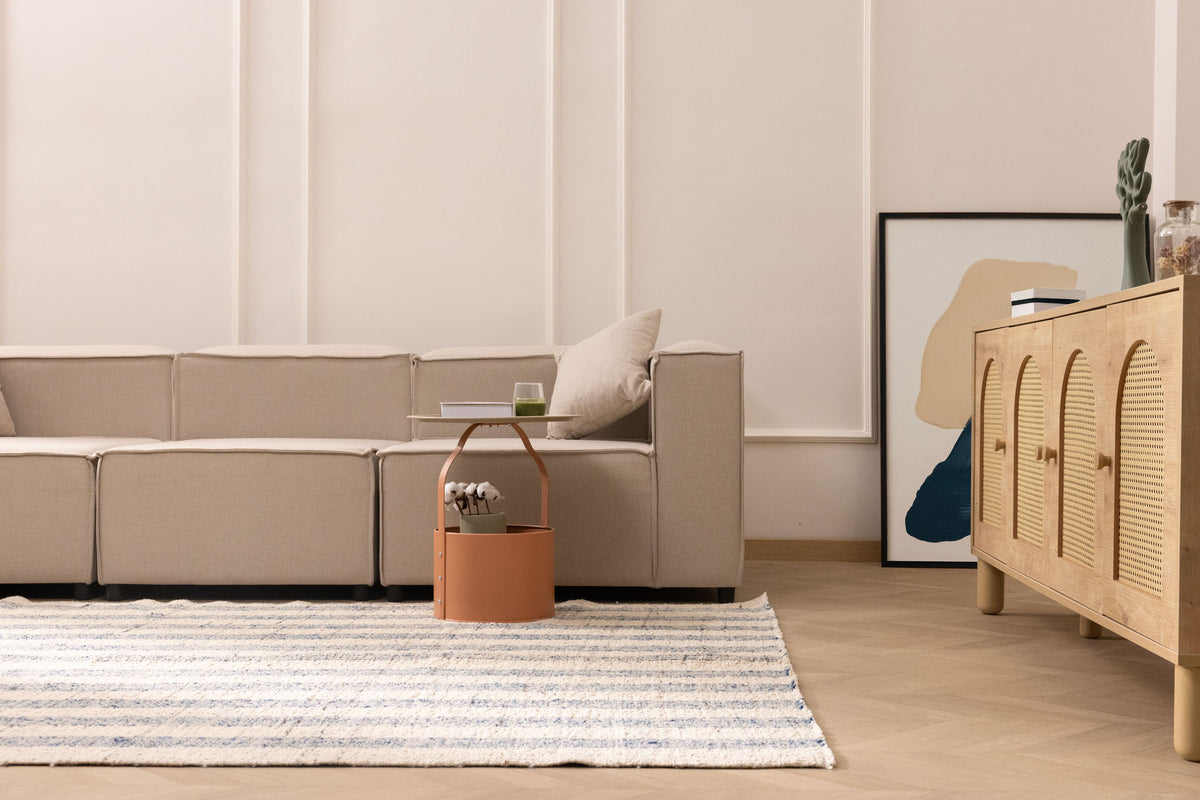Handwoven white and blue striped wool-blend flatweave rug in a modern living room setting.