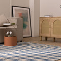 Blue and white checkered wool-blend flatweave rug in a modern living room setting.