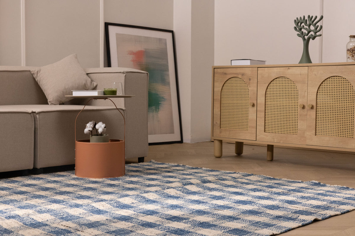 Blue and white checkered wool-blend flatweave rug in a modern living room setting.