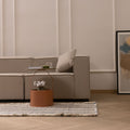 Handwoven white and blue striped wool-cotton flatweave rug with decorative fringe in a modern living room.