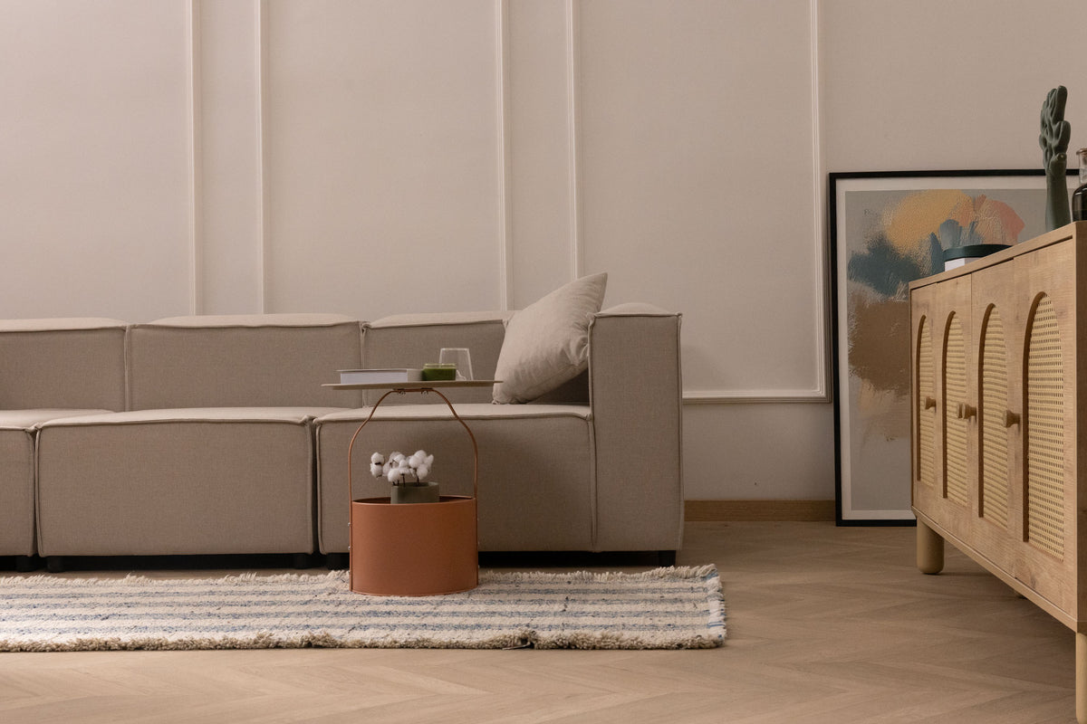 Handwoven white and blue striped wool-cotton flatweave rug with decorative fringe in a modern living room.