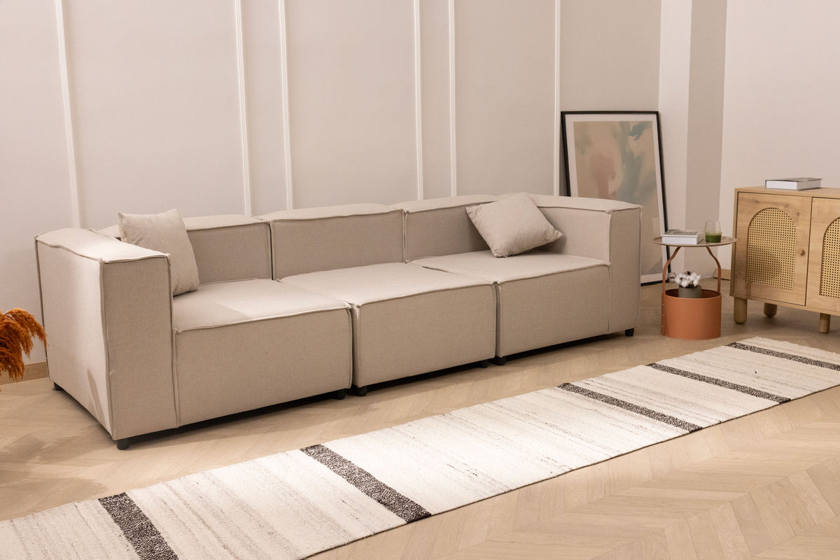 Handwoven white and black wool-blend flatweave runner rug on a light wood herringbone floor in a modern living room.